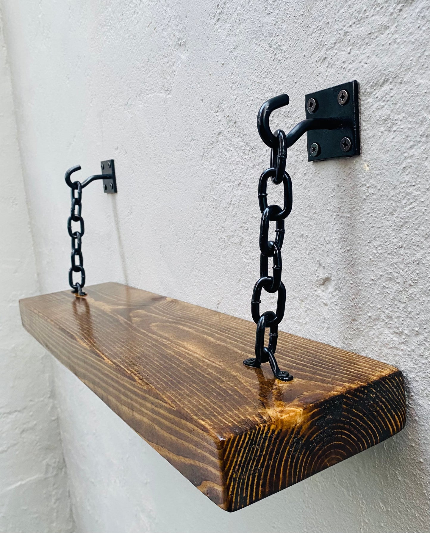 Natural oak wood shelf with black hook and chain brackets wall mounted