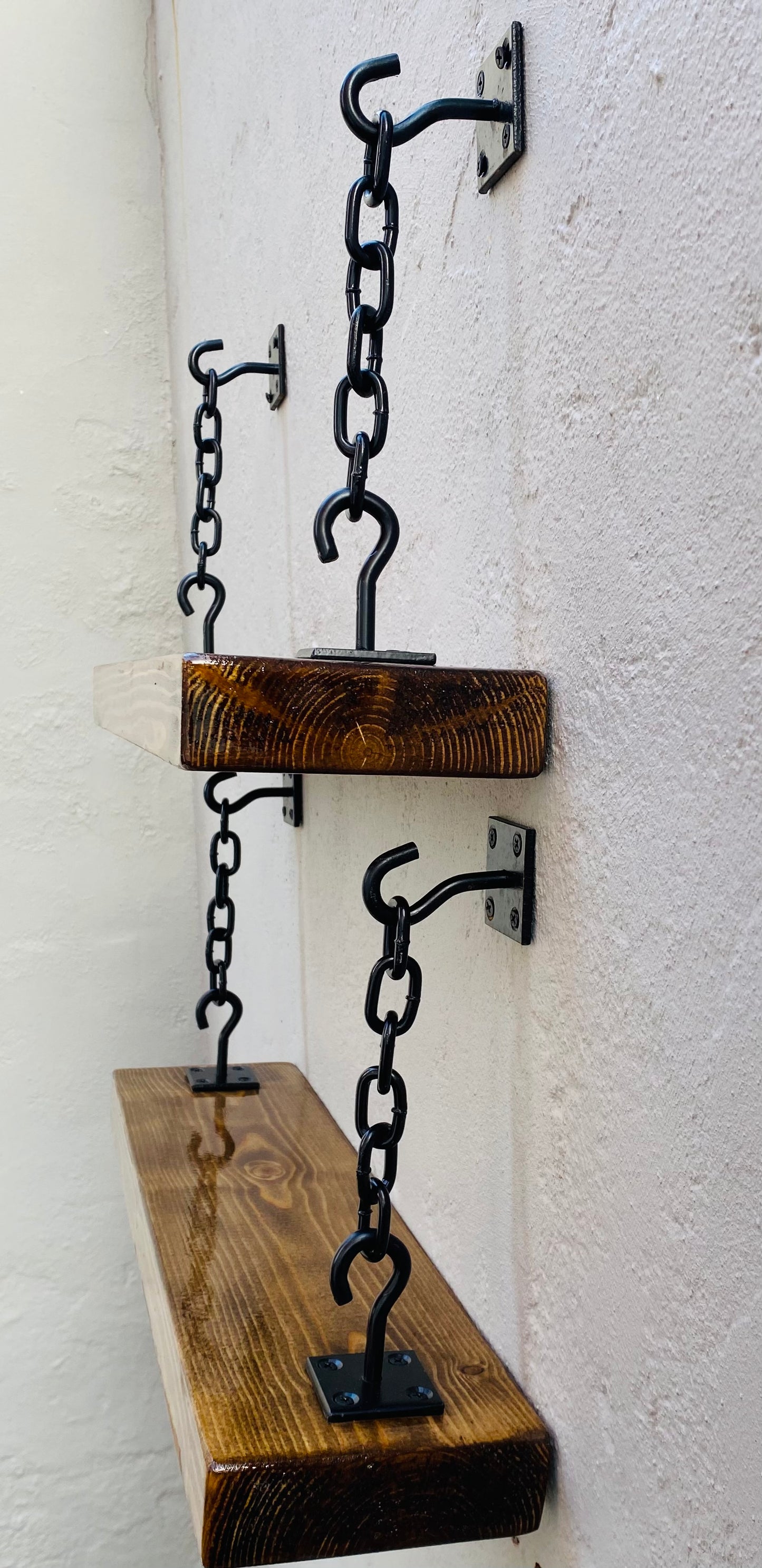 Wall mounted shelves with black hook and chain brackets
