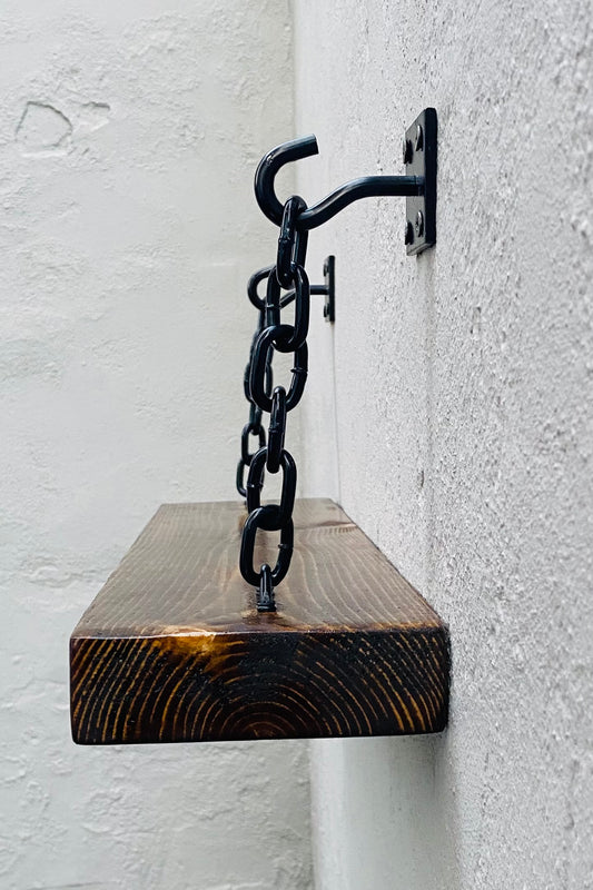 Industrial style dark wood shelf with black hook and chain shelf brackets wall mounted