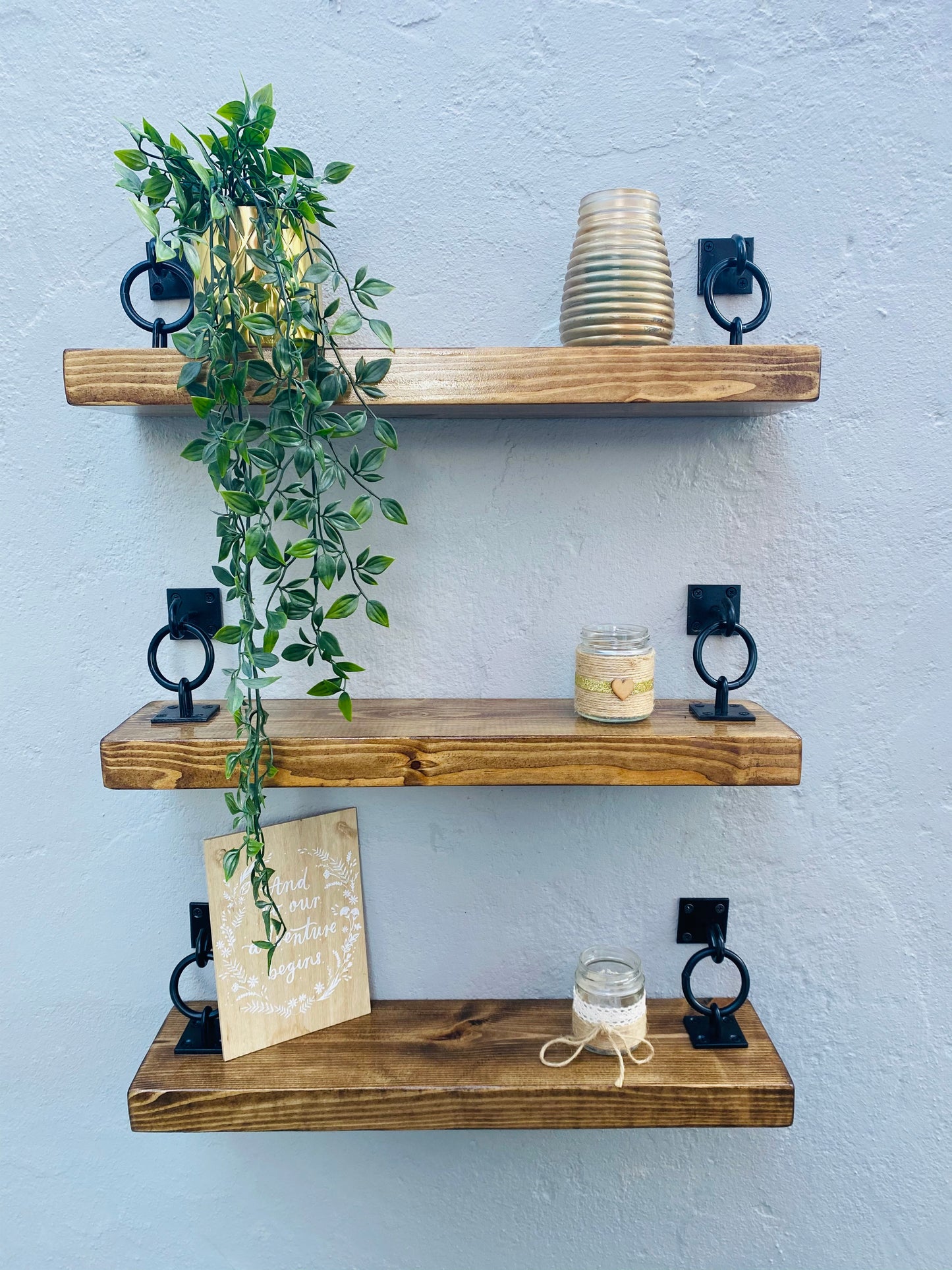 unique floating shelf design with decorative rings and a natural wood finish