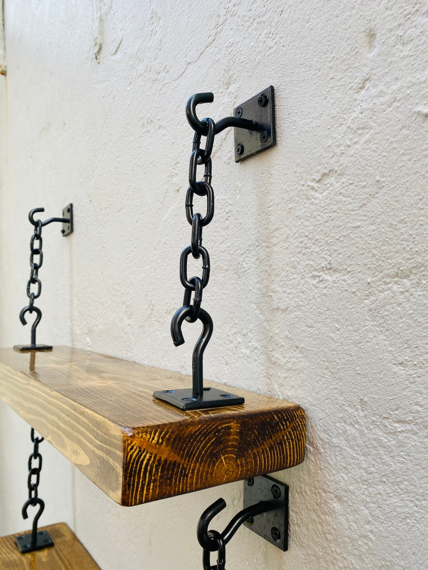 Rustic industrial floating shelf with black chain brackets